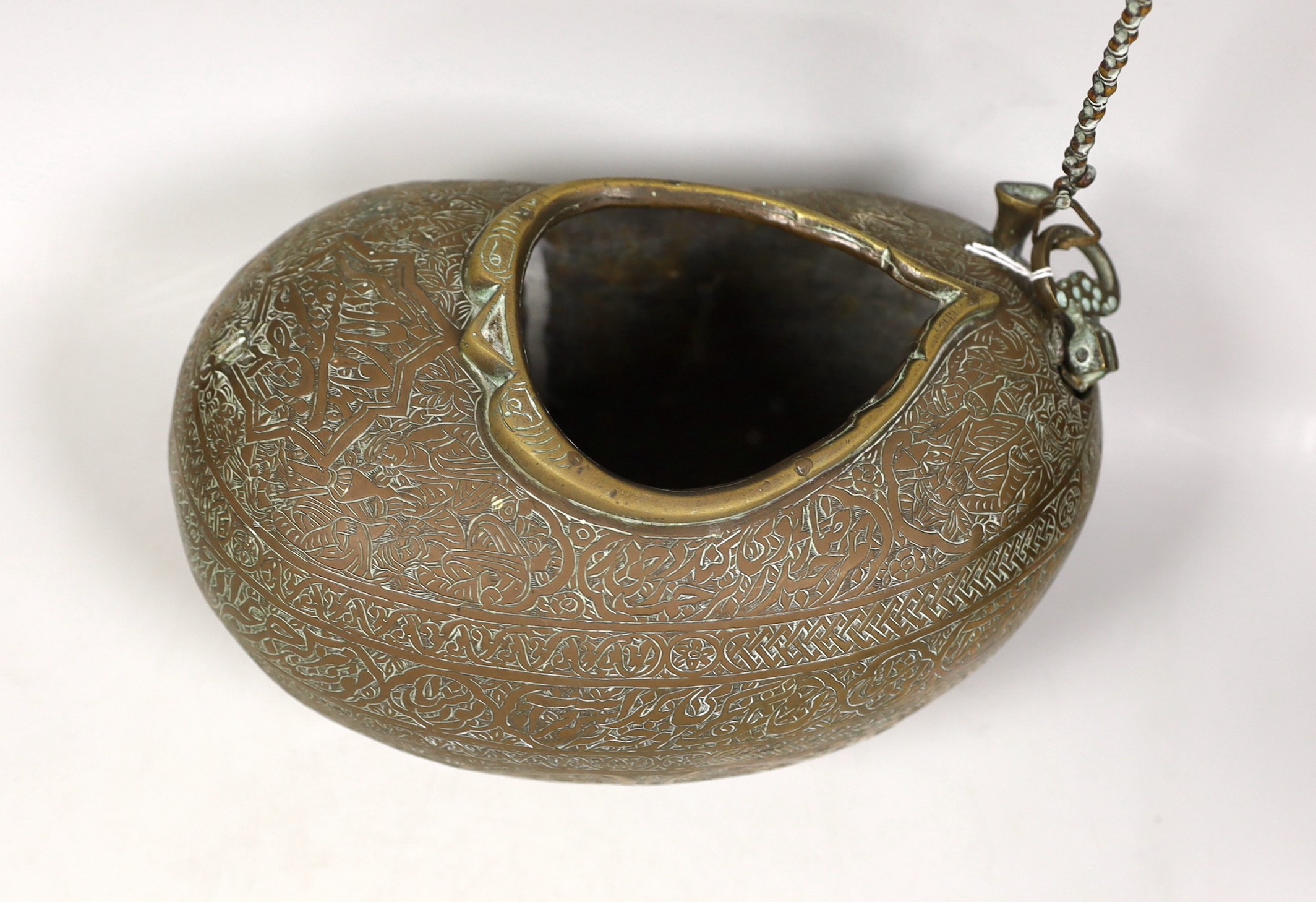 A 19th century Persian engraved brass kashkul, Qajar dynasty, 16cm wide and a bronze kettle, 17cm tall